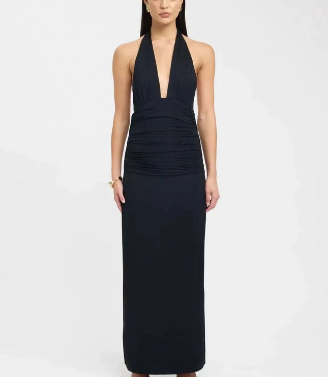Back view of a black maxi dress with open back, tie waist detail, and long skirt