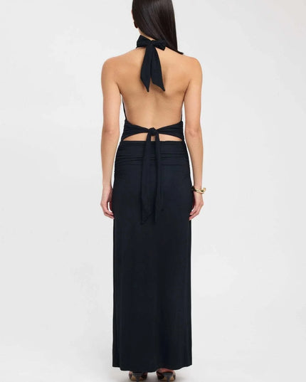 Side view of a pale yellow halter maxi dress with open back and gathered waist