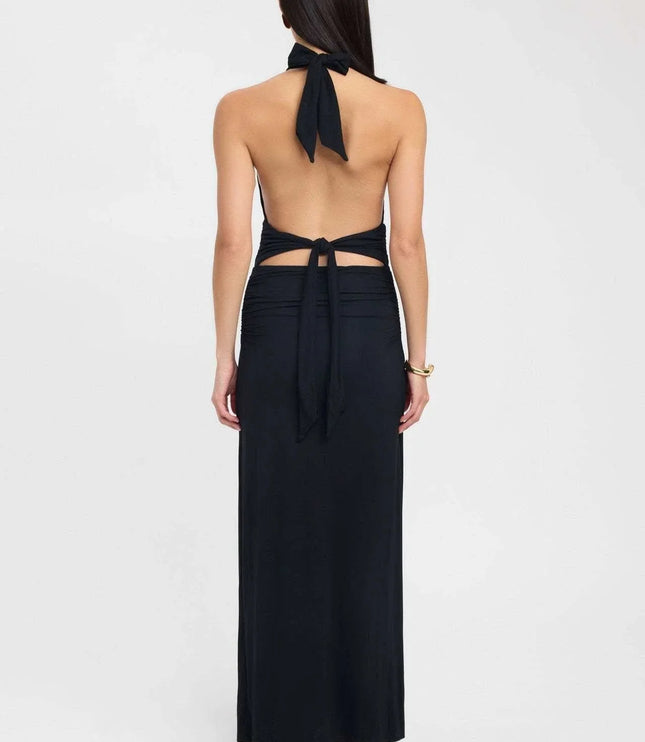 Side view of a pale yellow halter maxi dress with open back and gathered waist