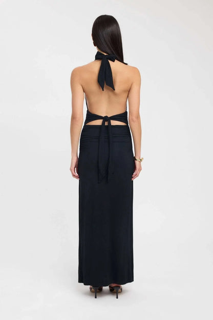Side view of a pale yellow halter maxi dress with open back and gathered waist