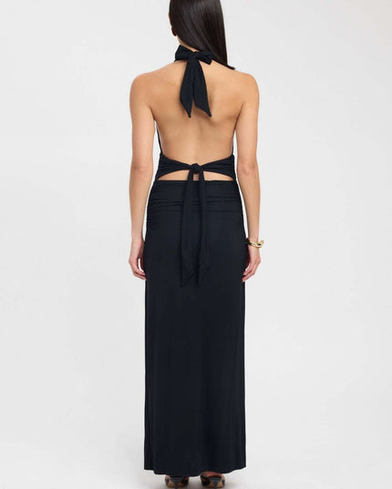 Side view of a pale yellow formal maxi dress with low open back and ruched hip detail