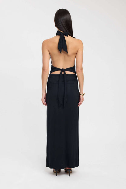 Side view of a pale yellow formal maxi dress with low open back and ruched hip detail