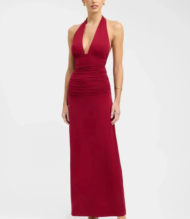 Back view of a black halter maxi dress with open back, tie neck, and tie waist