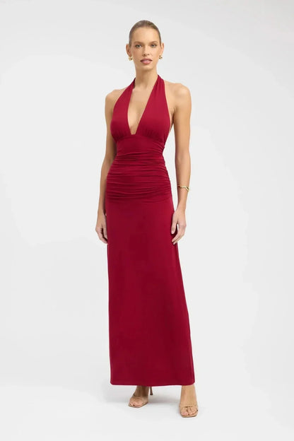Back view of a black halter maxi dress with open back, tie neck, and tie waist