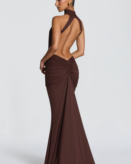 Side back view of brown ruched maxi dress showing halter neckline and open back