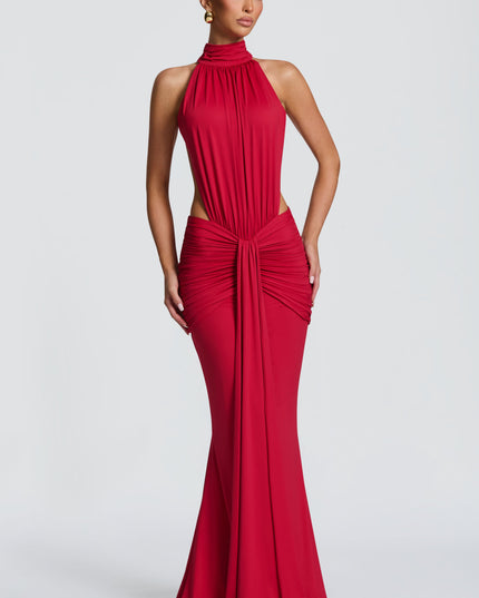 Front view of a red ruched halter maxi dress with high neckline and side cutouts