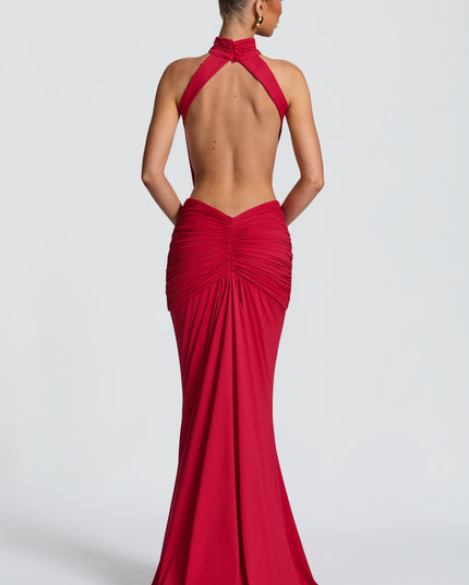 Back view of a red backless maxi dress with halter straps and gathered skirt detail
