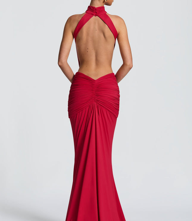 Back view of a red backless maxi dress with halter straps and gathered skirt detail