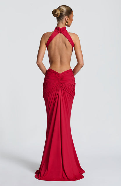 Back view of a red backless maxi dress with halter straps and gathered skirt detail