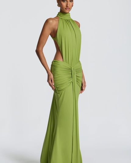 Side angle of green formal maxi dress showing ruched waist and flowing skirt