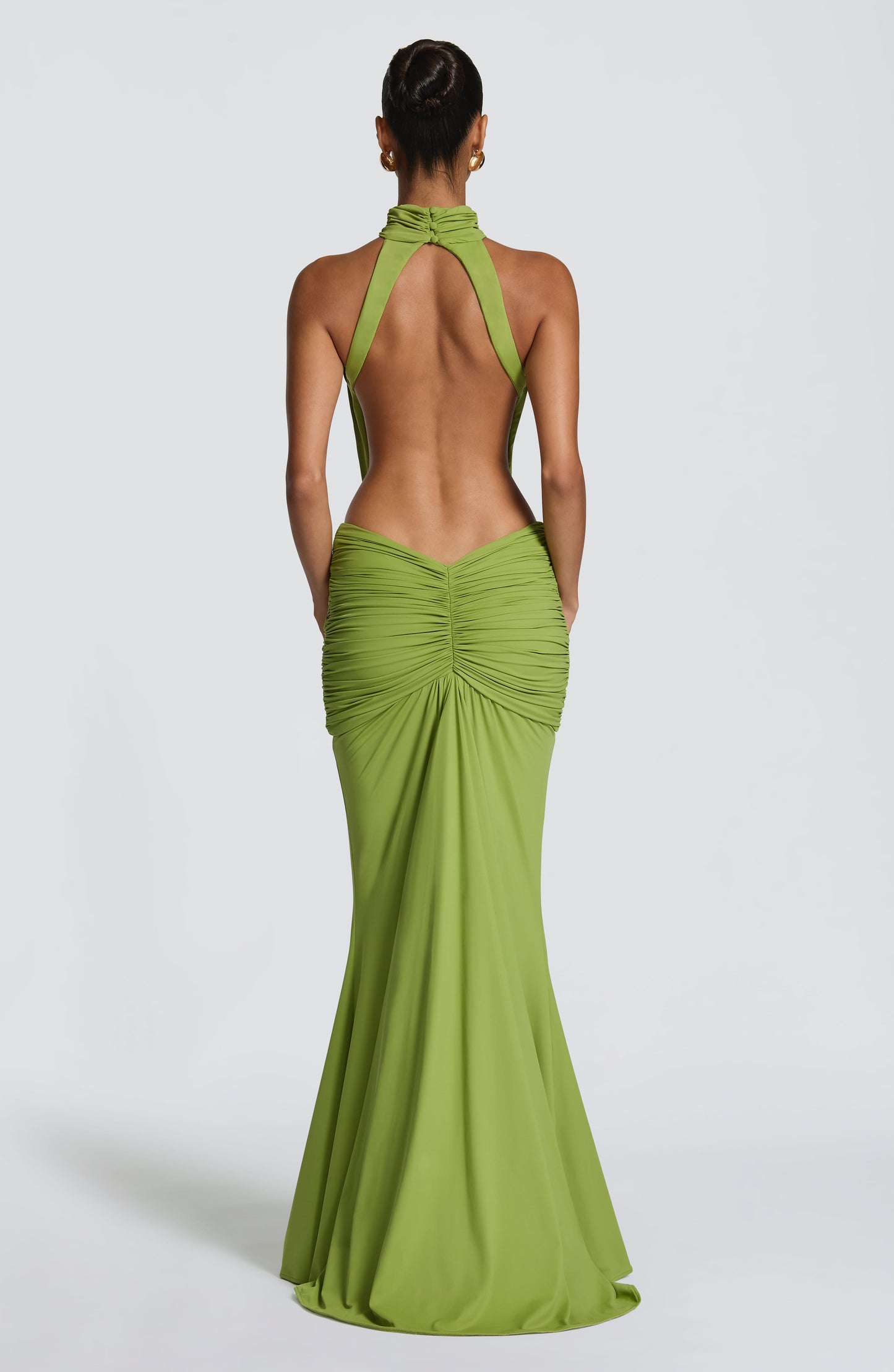 Back view of green ruched maxi dress with open back and fitted skirt
