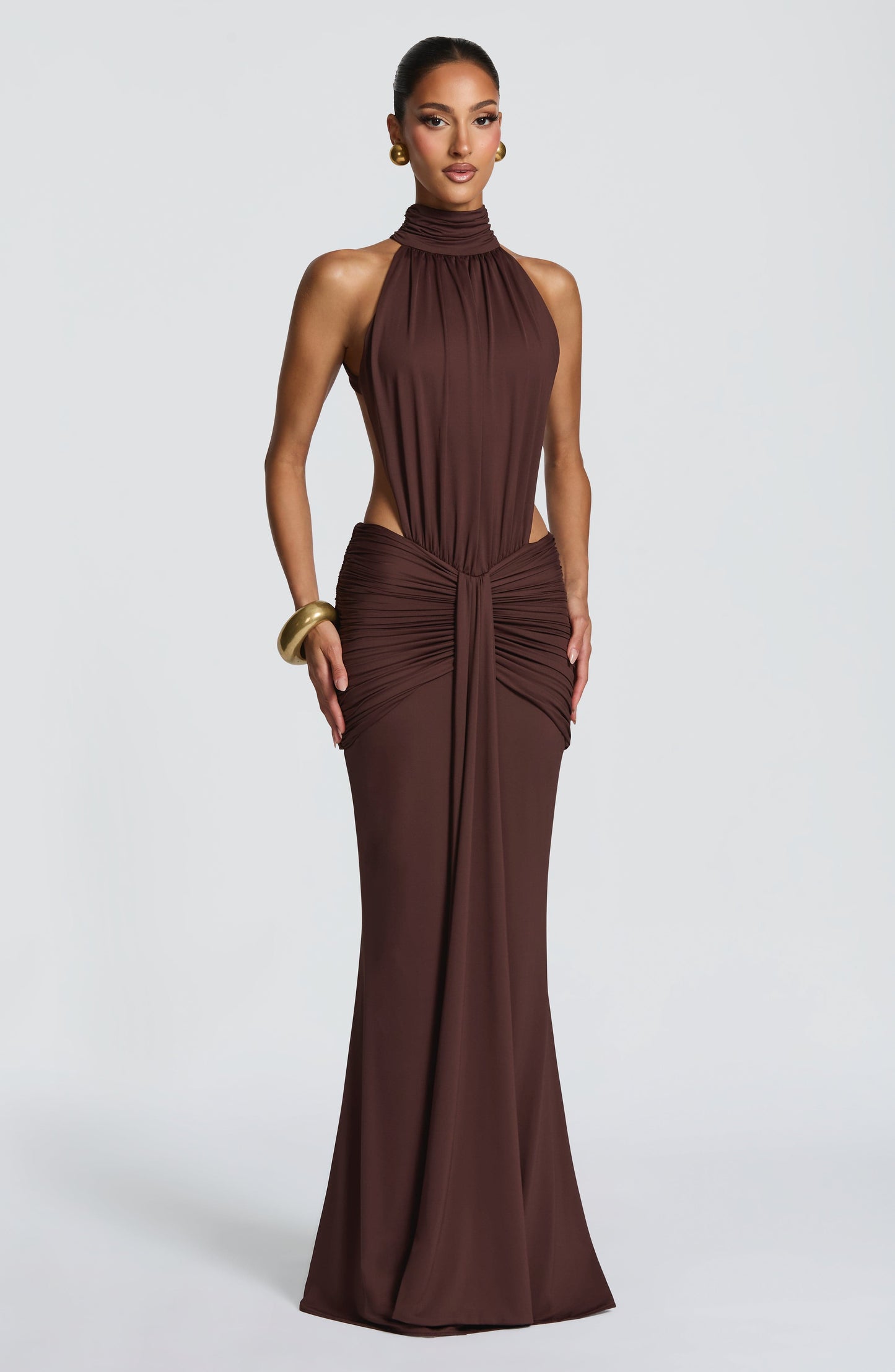 Front view of brown ruched halter maxi dress with high neck and side cutouts