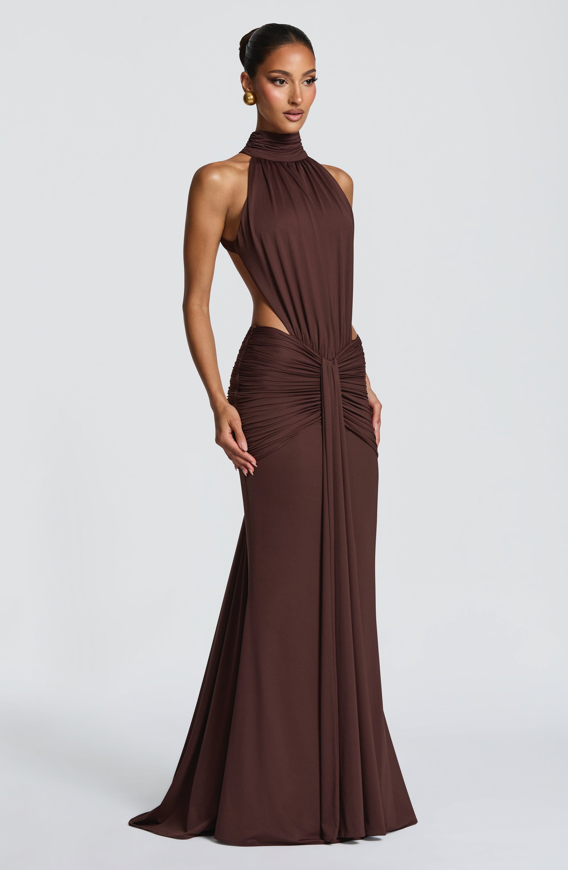 Back view of brown formal maxi dress with open back and ruched hip detail