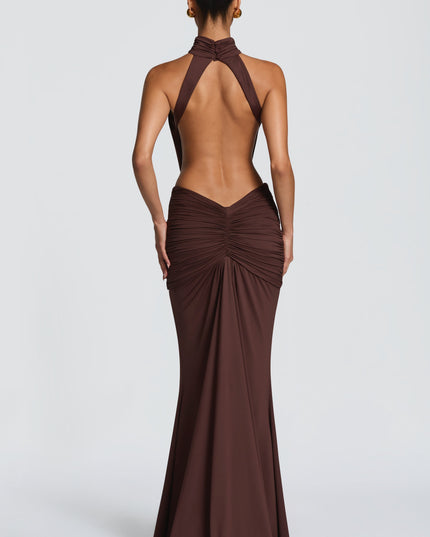 Side view of brown halter maxi dress with draped bodice and floor-length skirt