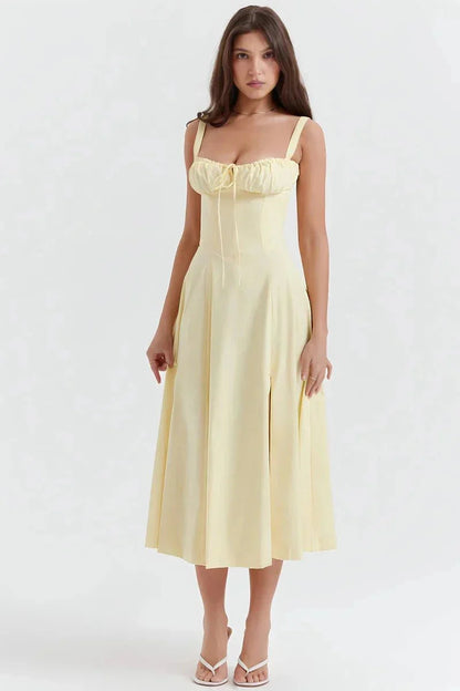 Pale yellow floral midi dress with ruched bust, wide straps, and flared skirt