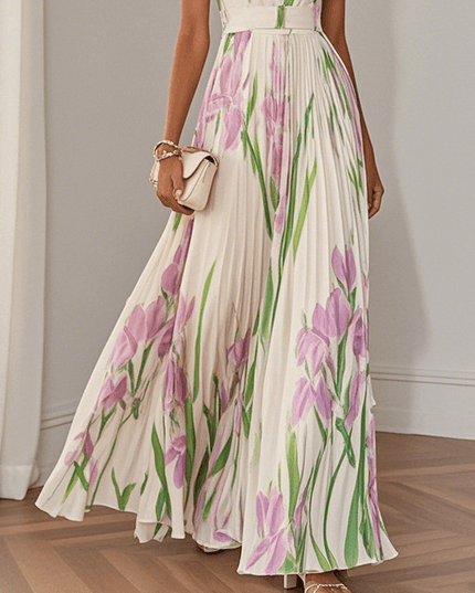 Midsection view of women's summer floral maxi dress with pleated skirt and pink green botanical print