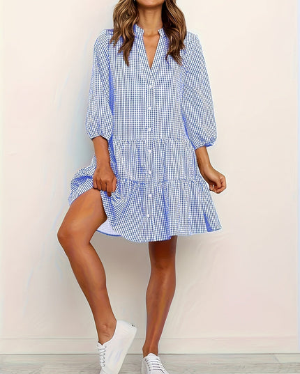 Blue gingham summer dress with V neck, long sleeves, and tiered mini skirt