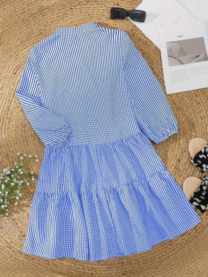Blue gingham V neck mini dress laid flat with tiered skirt and long puff sleeves