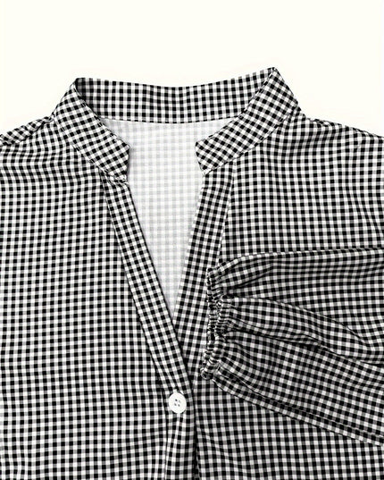 Close-up of black gingham V neck mini dress with collar, button front, and sleeve cuff