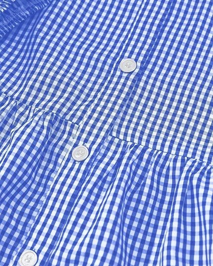 Close-up of blue gingham dress fabric with button front and gathered tier seam