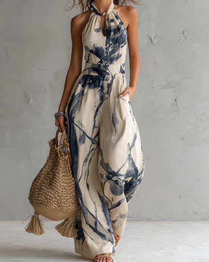 Cream and navy printed halter neck wide leg jumpsuit with pockets, full length front view