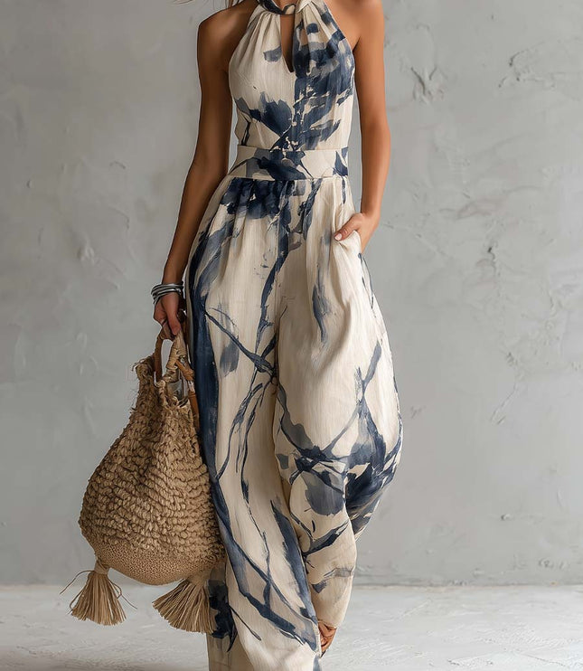 Cream and navy printed halter neck wide leg jumpsuit with pockets, full length front view
