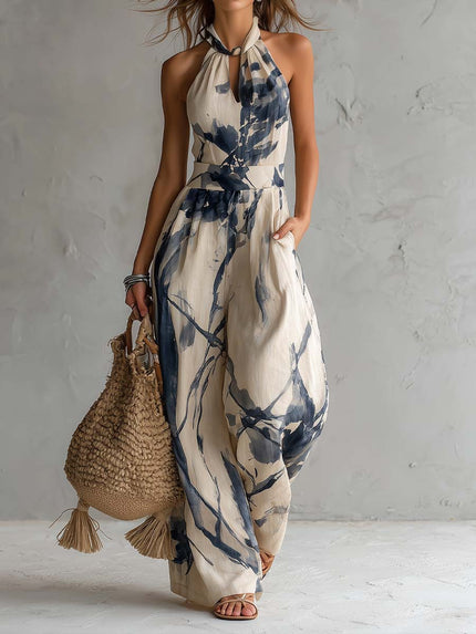 Cream and navy printed halter neck wide leg jumpsuit with pockets, full length front view