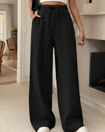Black women's high waisted linen pants with wide legs, adjustable drawstring, and loose fit