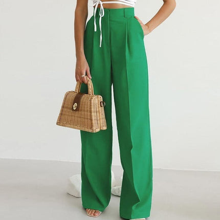 Green high waisted wide leg linen pants styled with a white crop top and woven handbag