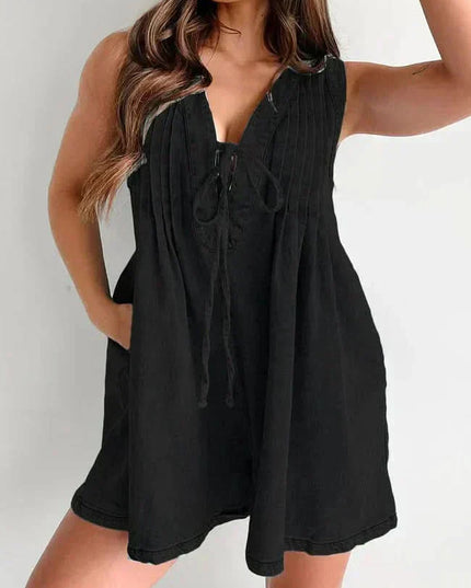 Black women's denim romper with sleeveless V-neck, tie front, and loose mini short silhouette