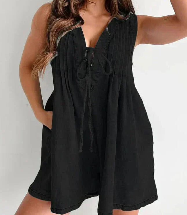 Black women's denim romper with sleeveless V-neck, tie front, and loose mini short silhouette
