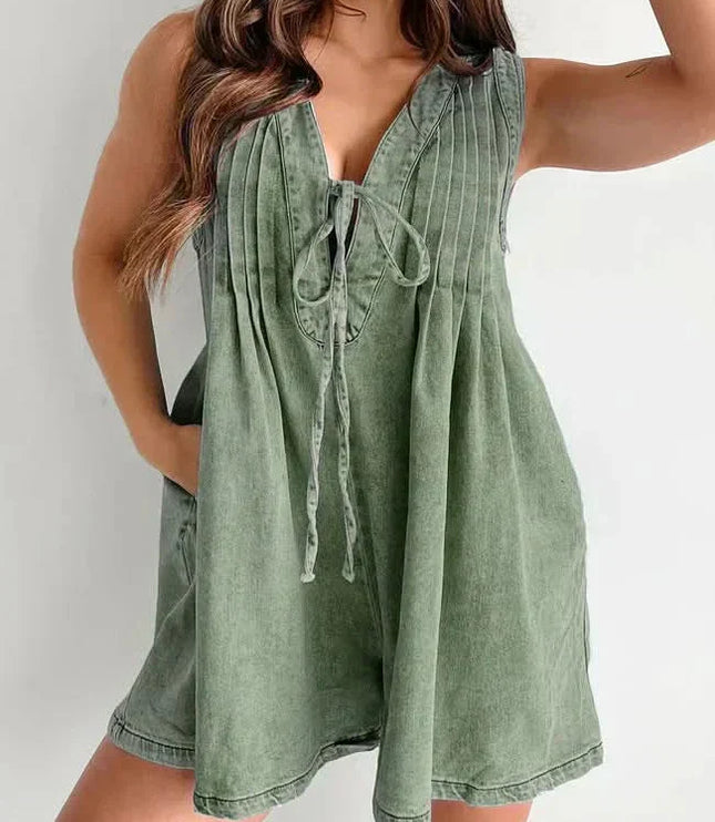 Olive green women's mini denim romper with V-neck tie front, pleated top, and relaxed shorts fit