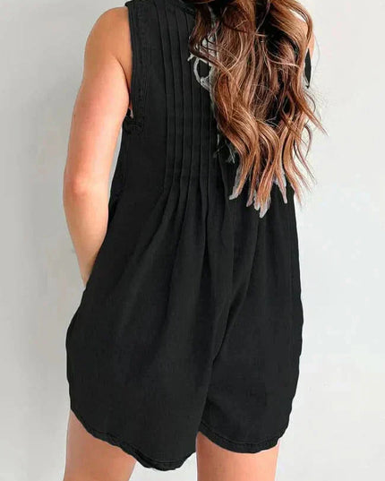 Back view of black casual denim romper with pleated back detail and relaxed sleeveless cut
