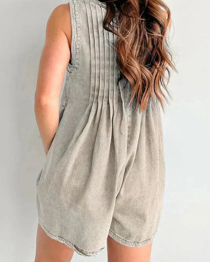 Back view of beige women's denim romper with soft pleats, sleeveless shoulders, and mini length