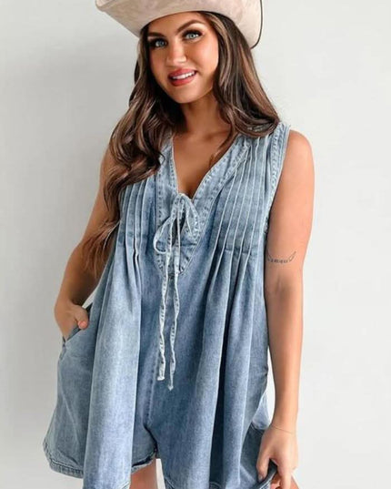 Light blue women's casual mini denim romper with pleated front, V-neck tie detail, and sleeveless cut