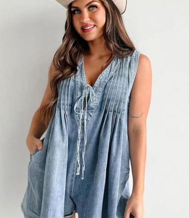 Light blue women's casual mini denim romper with pleated front, V-neck tie detail, and sleeveless cut
