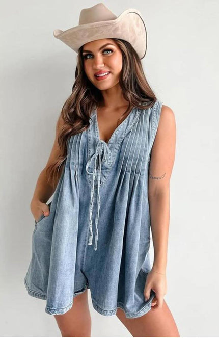 Light blue women's casual mini denim romper with pleated front, V-neck tie detail, and sleeveless cut