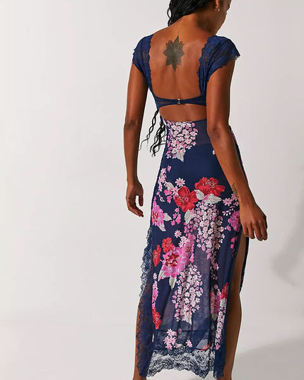 Back view of navy floral midi dress with open back, lace sleeves, and side slit