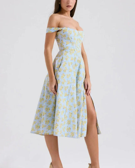Side view of a floral off shoulder midi dress with fitted bodice and front slit