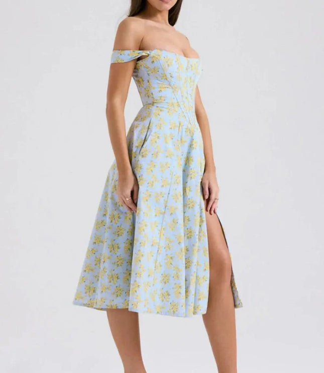 Side view of a floral off shoulder midi dress with fitted bodice and front slit
