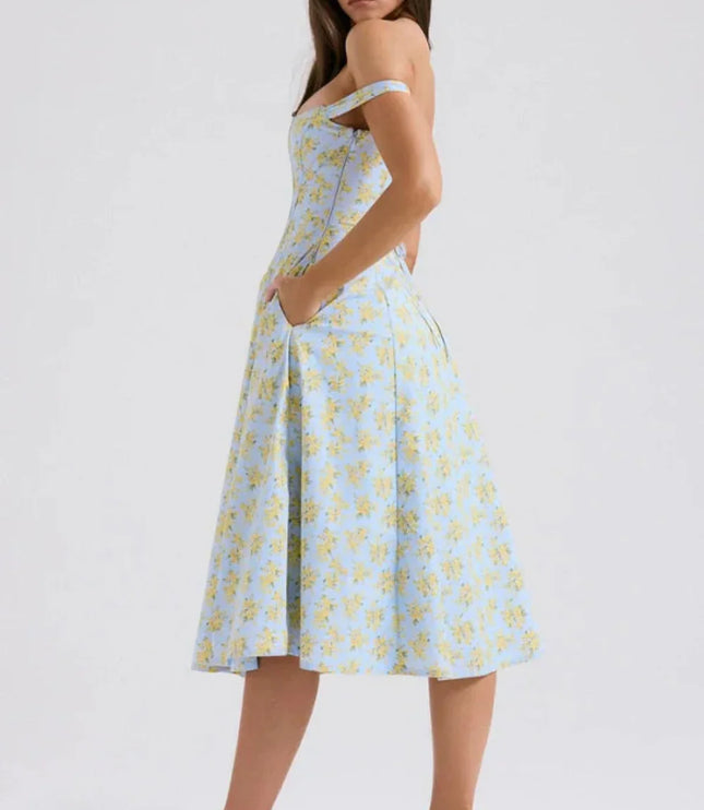 Three-quarter back view of a blue floral midi dress with off shoulder sleeves and slit