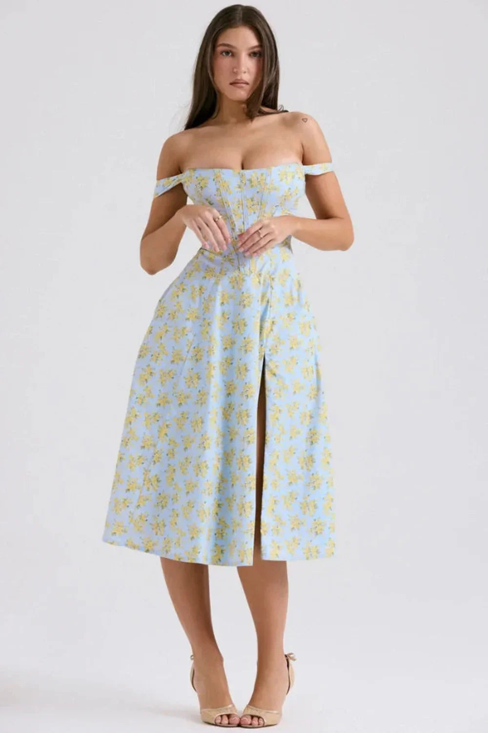 Front view of a floral off shoulder midi dress with structured top and center slit