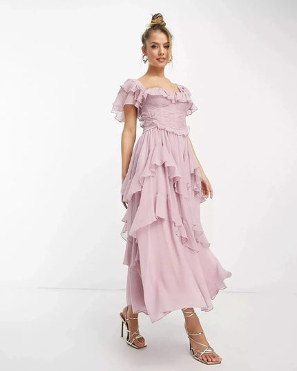 Front view of blush pink wedding guest ruffle midi dress with square neckline and tiered chiffon skirt