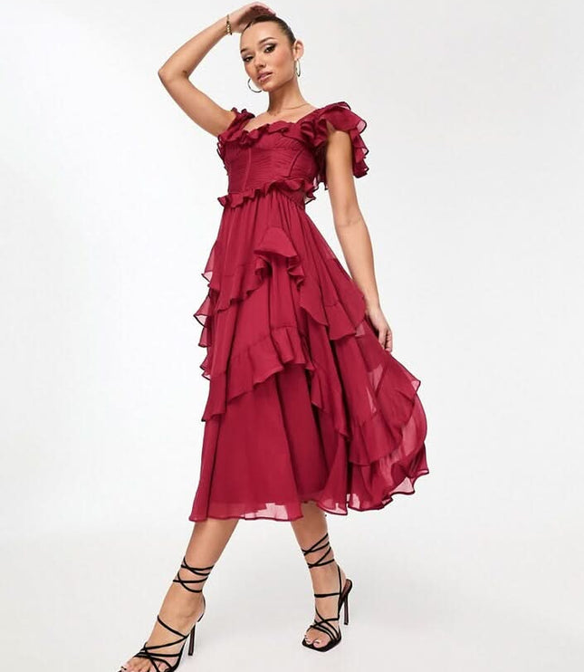 Close-up of blush pink ruffle midi dress showing textured bodice, square neckline, and layered trim