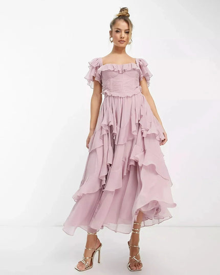 Blush pink ruffle midi dress with off-shoulder sleeves and flowing layered skirt, wedding guest dress