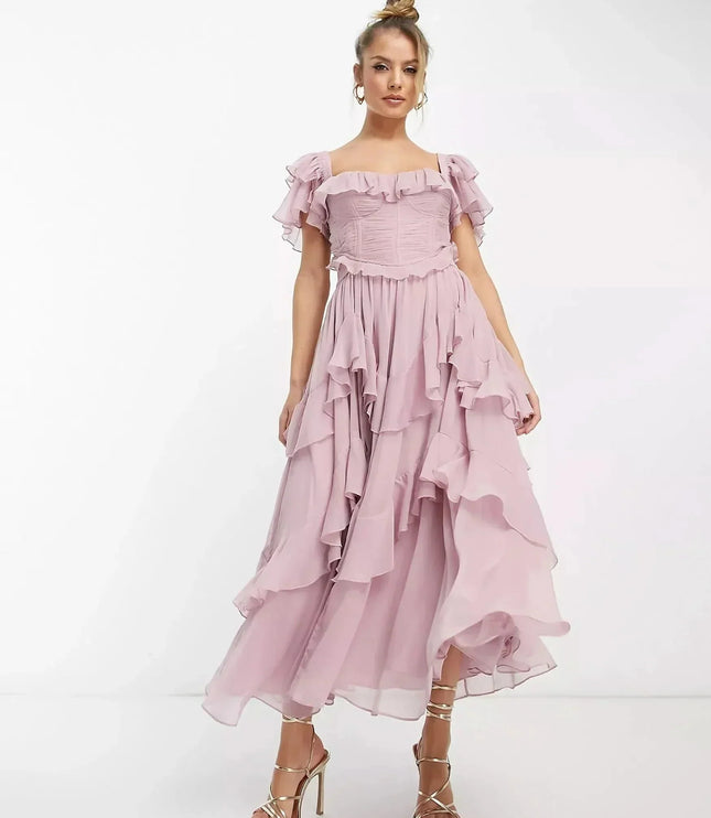 Blush pink ruffle midi dress with off-shoulder sleeves and flowing layered skirt, wedding guest dress