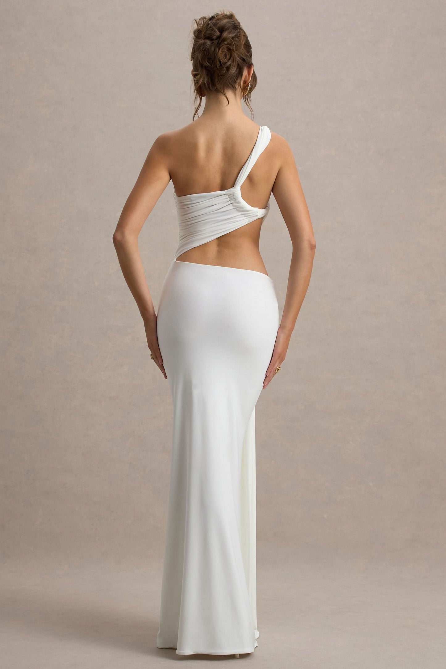 Back view of white one shoulder maxi dress with open back and fitted long skirt