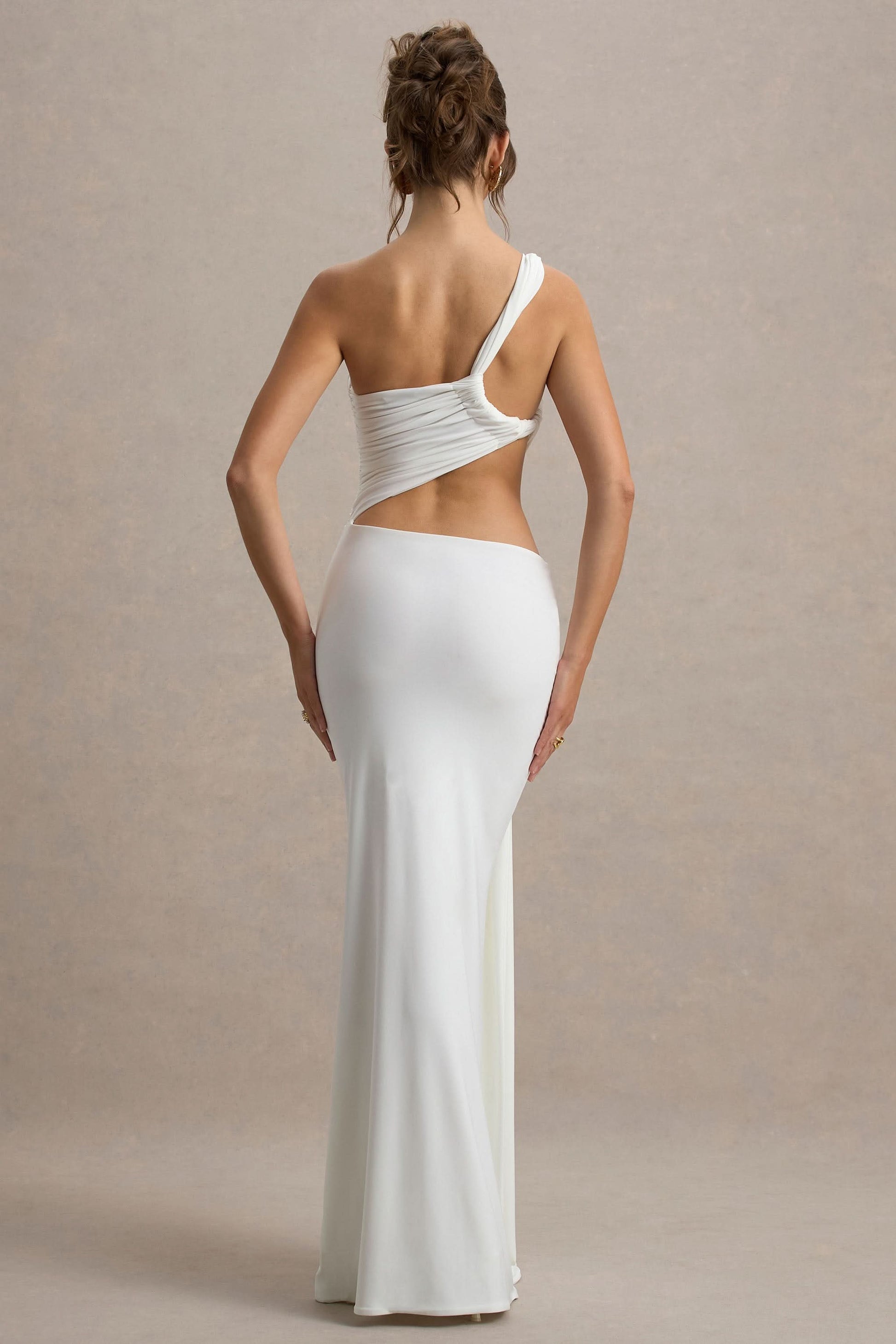 Back view of white one shoulder maxi dress with open back and fitted long skirt