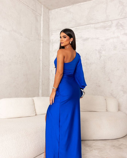 Back view of royal blue satin maxi dress with one shoulder and long drape