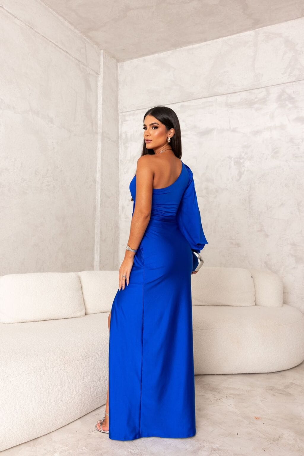 Back view of royal blue satin maxi dress with one shoulder and long drape